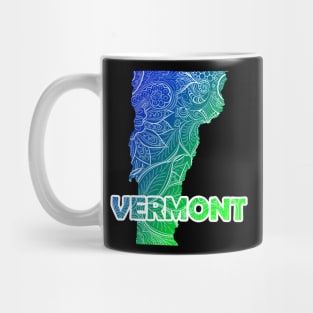 Colorful mandala art map of Vermont with text in blue and green Mug